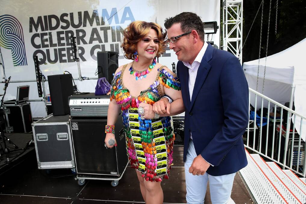 Dolly Diamond leads Daniel Andrews to the stage in central Melbourne’s Alexandra Gardens. Picture: FAIRFAX