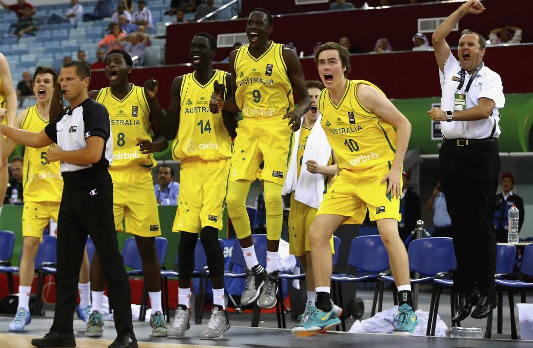 Trent McMullan (No. 10) and the rest of the Australian bench celebrate the Goannas’ semi-final comeback win over Spain on Saturday. Picture: GETTY IMAGES