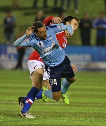 Tense affair: Sydney FC striker Alex Brosque is fouled by a Sydney United player. Photo: Brendan Esposito