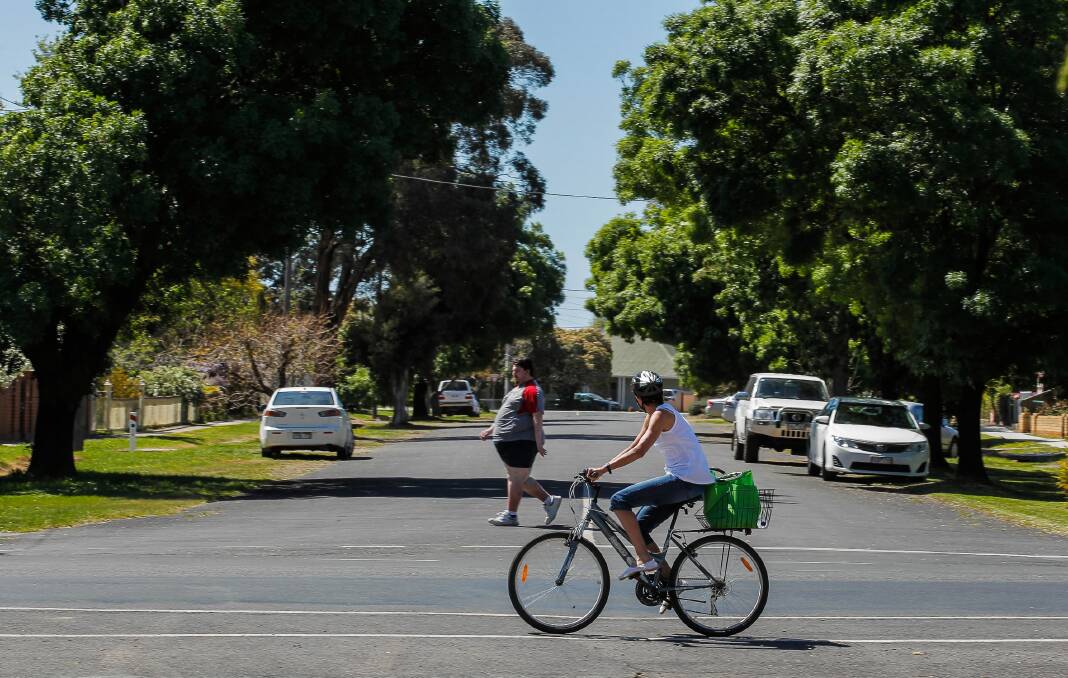 A cyclist looks down Gray Street in Benalla where a woman died on Monday night. Picture: DYLAN ROBINSON