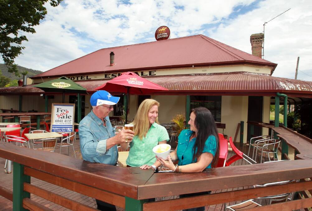 The new owners of the historic Eskdale Hotel Noel Perdon and Jodien Mason, right, look forward to serving outgoing owner Denise Raue. Picture: KYLIE ESLER