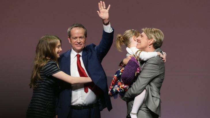 Opposition Leader Bill Shorten is hugged by his daughter Georgette as his other daughter Clementine embraces Deputy Opposition Leader Tanya Plibersek after the ALP National Conference on Friday. Photo: Andrew Meares