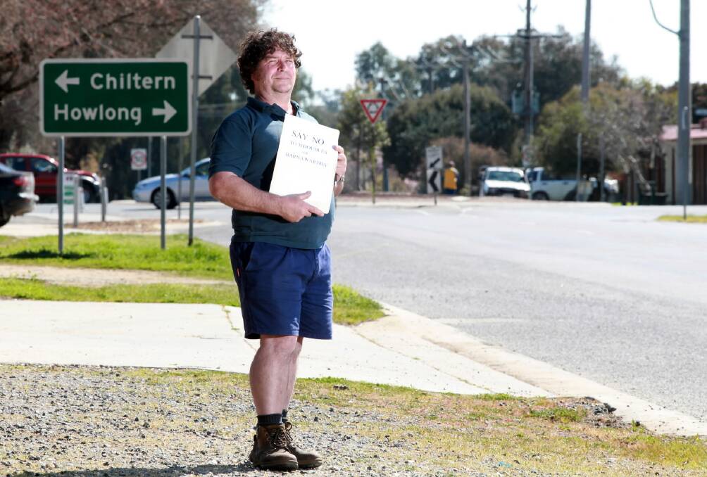 Jonathan Riley, standing in Havelock Street with his petition, wants Indigo Shire to ban B-doubles from passing through Barnawartha because of the danger they pose to residents. Picture: MATTHEW SMITHWICK