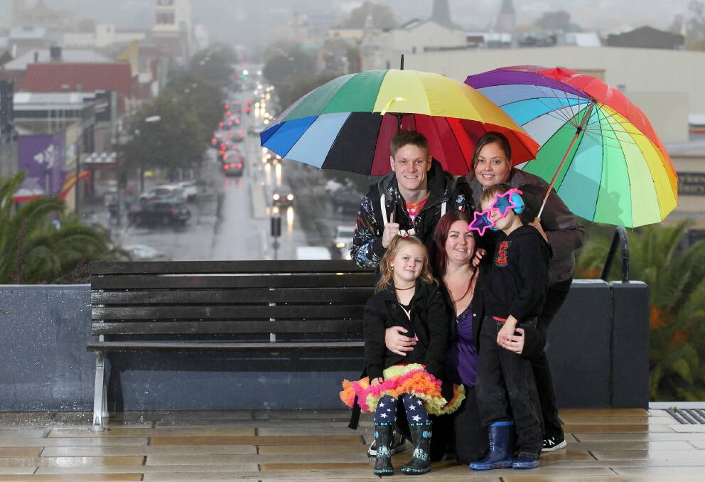 The rain stopped the rally but not the support of Mark Green and Mel Smith, Aurora-dannen Taylor, 5, Tamara Taylor and Michael Taylor, 7, for a new group for family members and friends of gays and lesbians. Picture: KYLIE ESLER