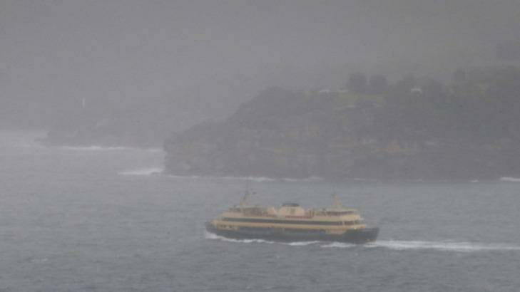 A barely visible Manly ferry makes its way from the city. Photo: Peter Rae