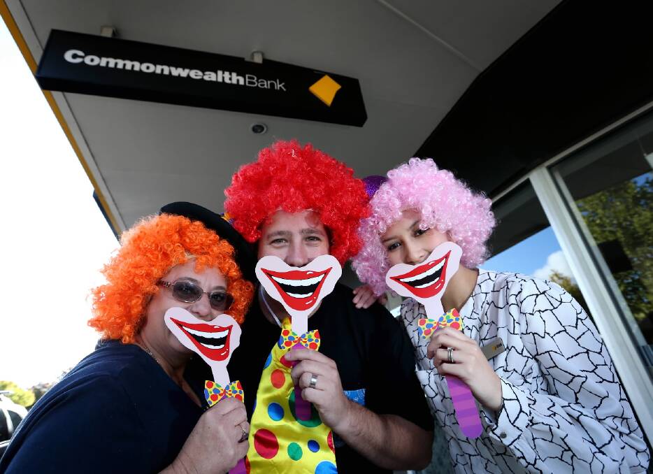 Commonwealth Bank staff Virginia Mitchell, Cameron O’Connor and Linh Atsanani dressed as clowns to raise money for Clown Doctors ... branches in the region aim to collectively raise $5000. Picture: MATTHEW SMITHWICK