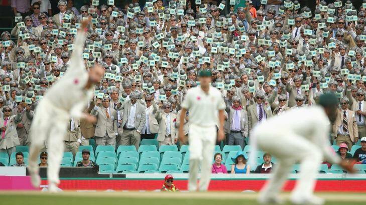 Great atmosphere: Nathan Lyon bowls as the Richie Benaud impessonators hold up their microphones during day two of the third Test match between Australia and the West Indies at Sydney Cricket Ground. Photo: Mark Kolbe