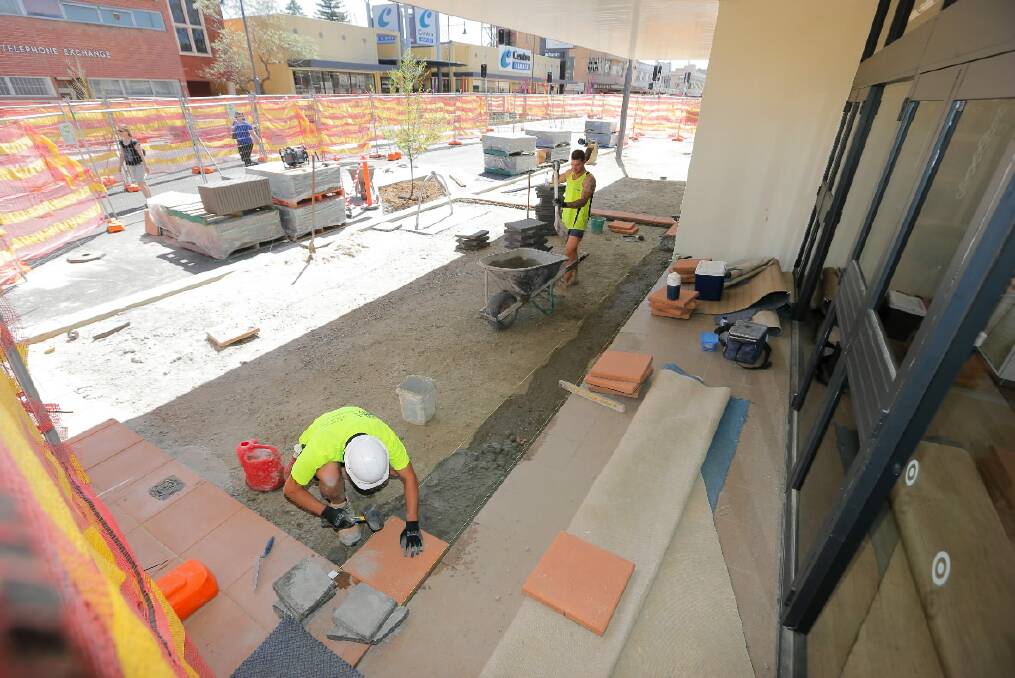 Construction workers pave the area of Kiewa Street at the front of Target as they finish the upgrading works on the Albury street. Picture: TARA GOONAN
