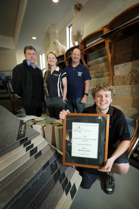 Nicholas Close has won Apprentice of the Year at the National Furnishing Industry Training Awards. He is pictured with Mark Willis, Else Dale and Peter Middleton. Picture: TARA GOONAN
