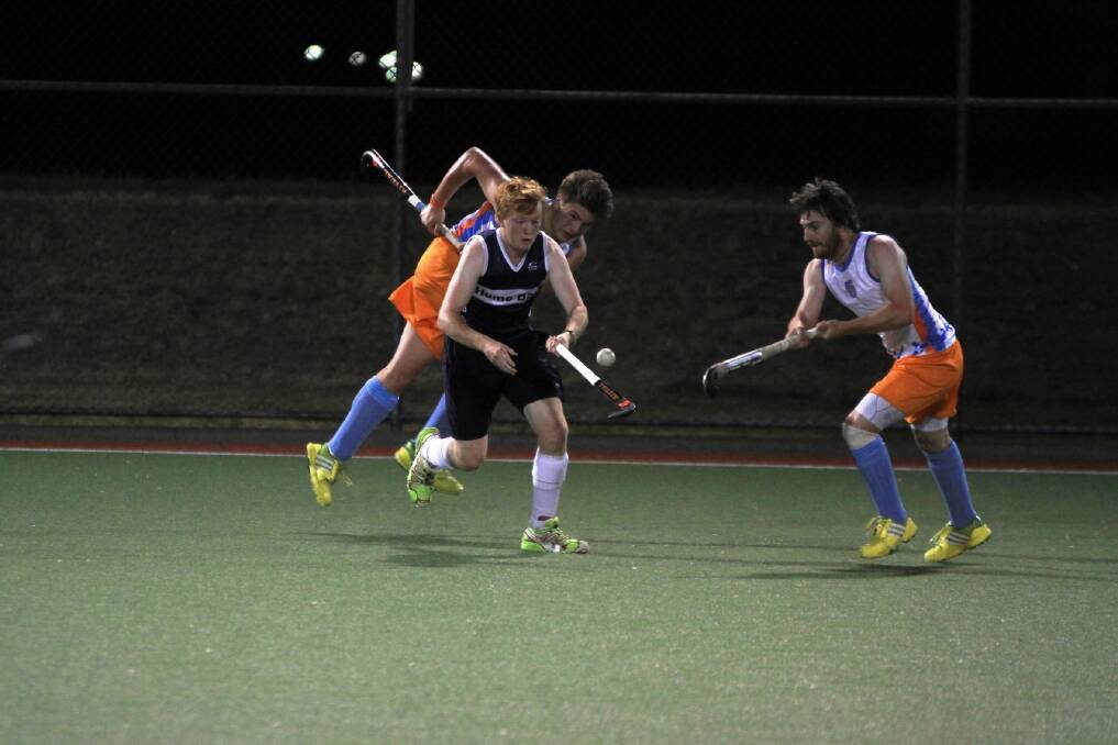 Hume Bank’s playmaker Luc Hinton has the attention of the X-Ray Group’s Jeremy Payne and Corie Norie in the opening round of Hockey 8s last Friday. This week it is do or die for the bank team. Picture: DON CULLEN