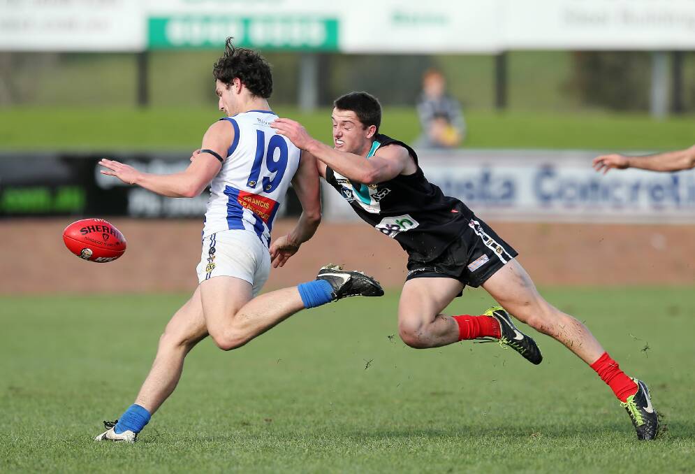 Lavington youngster Will Lenehan in typical form as he tackles Corowa-Rutherglen’s Jim Svarc last month. He will play for Victorian Country on Saturday.