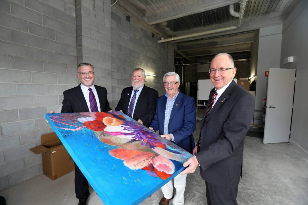 Fight Cancer Centre managing director Eric Wright, Albury North Rotary Club president David Thurling and Hilltop Carer Accommodation Centre associate directors Alf Armstrong and Peter Drummond hold a painting which the theme of a new children’s room will be based on. Picture: PETER MERKESTEYN