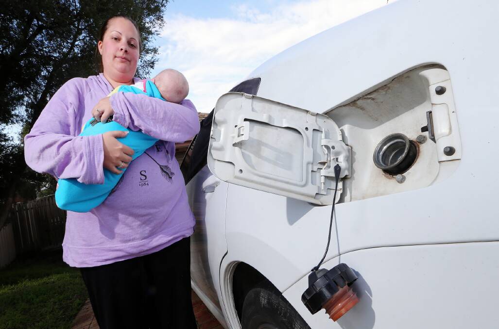 Celeste McIver and daughter Amelia-Mae Gilcrist, 12 weeks, with the damaged car. Picture: JOHN RUSSELL