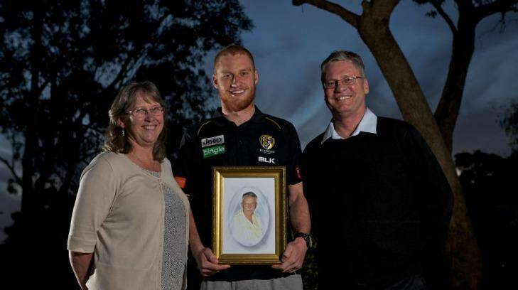 Three generations: Richmond's Nick Vlastuin holds a photo of his grandfather, Len or 'Opa', flanked by his parents. Photo: Jason South