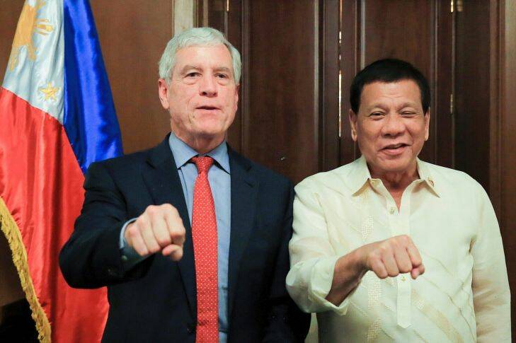 In this photo provided by Malacanang Palace, Philippine President Rodrigo Duterte, right, and Australian Secret Intelligence Service Director-General Nicolas Peter "Nick" Warner pose with a fist bump during the latter's courtesy call on the president at Malacanang Palace in Manila, Philippines, Tuesday, Aug. 22, 2017. (Albert Alcain/Malacanang Palace via AP)