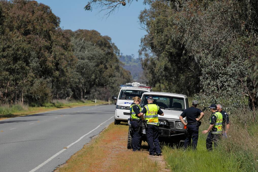 Police inspect a 4WD at Glenrowan which was later ruled out as not being involved. Picture: DYLAN ROBINSON
