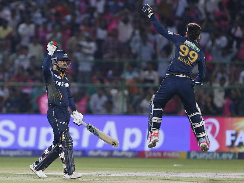 Rashid Khan salutes his matchwinning IPL boundary in Jaipur, while Noor Ahmad leaps for joy. (AP PHOTO)