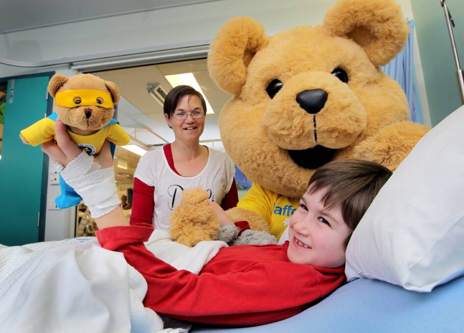 Sabrina Harrison and her son Tyrus, 7, from Gerogery, with Dougal the Bear at the children’s ward at Albury hospital yesterday. Picture: DAVID THORPE