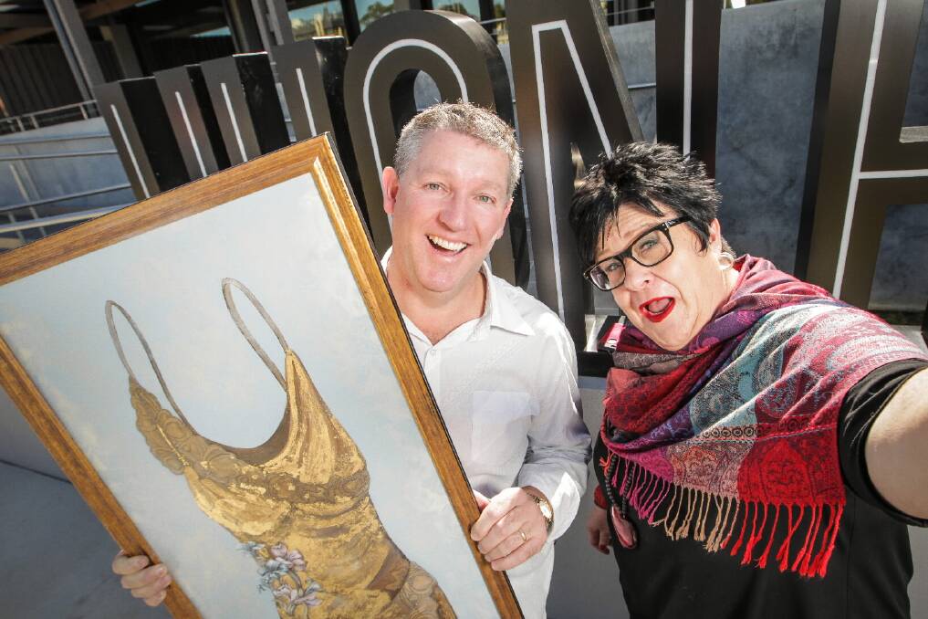 Dean Holley and Narelle Robinson with a painting by Beth Peters to be auctioned at the event. Picture: DYLAN ROBINSON