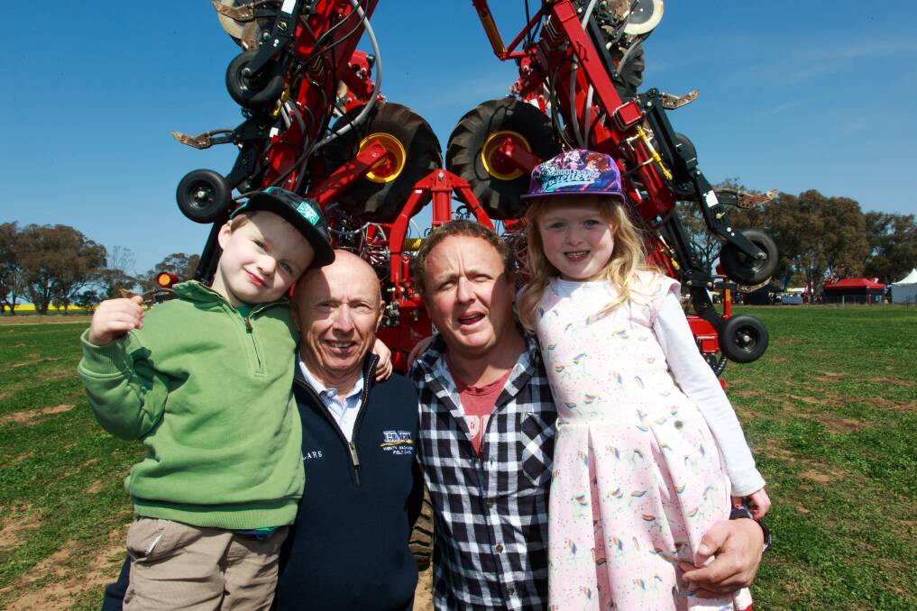 FUTURE FARMERS: Eloise 4, and Mason 4, Hicks from Tallangatta, with father Simon and granddad Graham Hicks, Henty Machinery Field Days coordinator. 