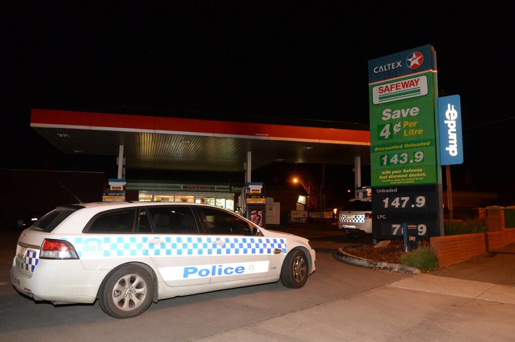 Manhunt: The service station was closed as police searched the area for the robber. PICTURE: KATE HEALY
