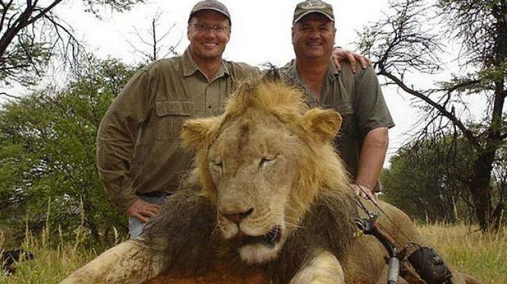 HUNTER BECOMES THE HUNTED: Hunter Walter James Palmer, left, with another lion he killed. Photo: FACEBOOK