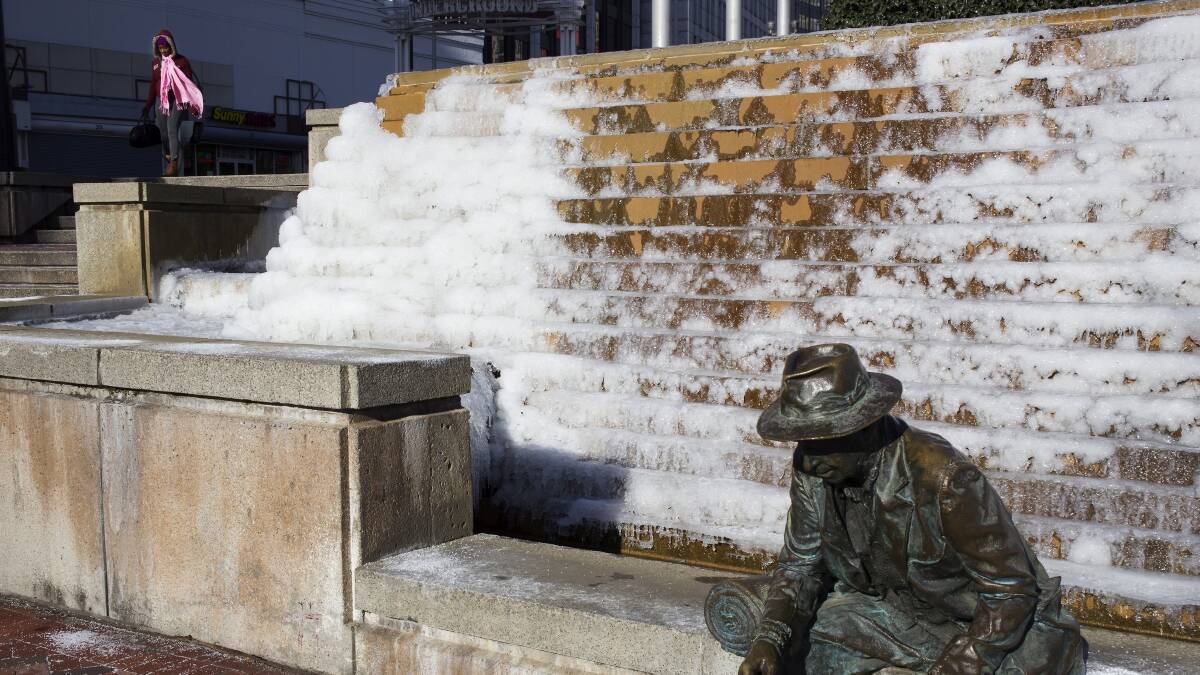 Keteria Neal passes by a fountain that has frozen over in downtown Atlanta, Georgia January 7, 2014. Photo: REUTERS/Chris Aluka Berry. 