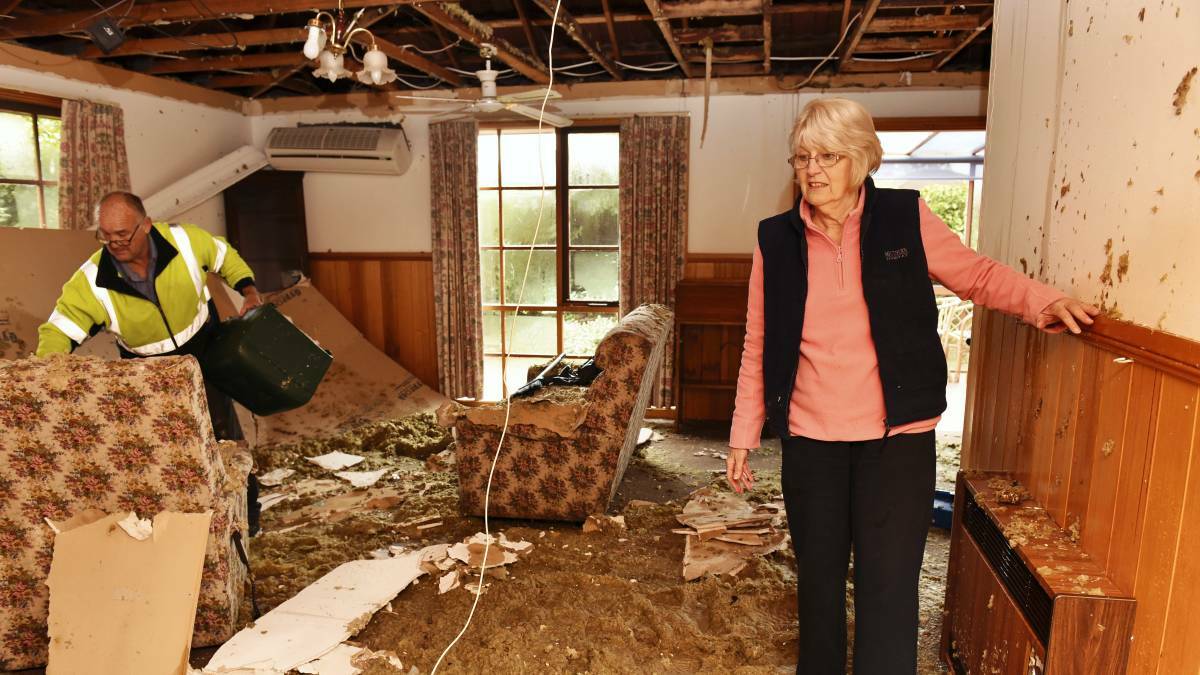Reg Woodhall, of Launceston Cleaning Service, and Linda Hughes survey the damage to the Prospect home of Ms Hughes’ 95-year-old father, Stephen Fagg. Picture: SCOTT GELSTON