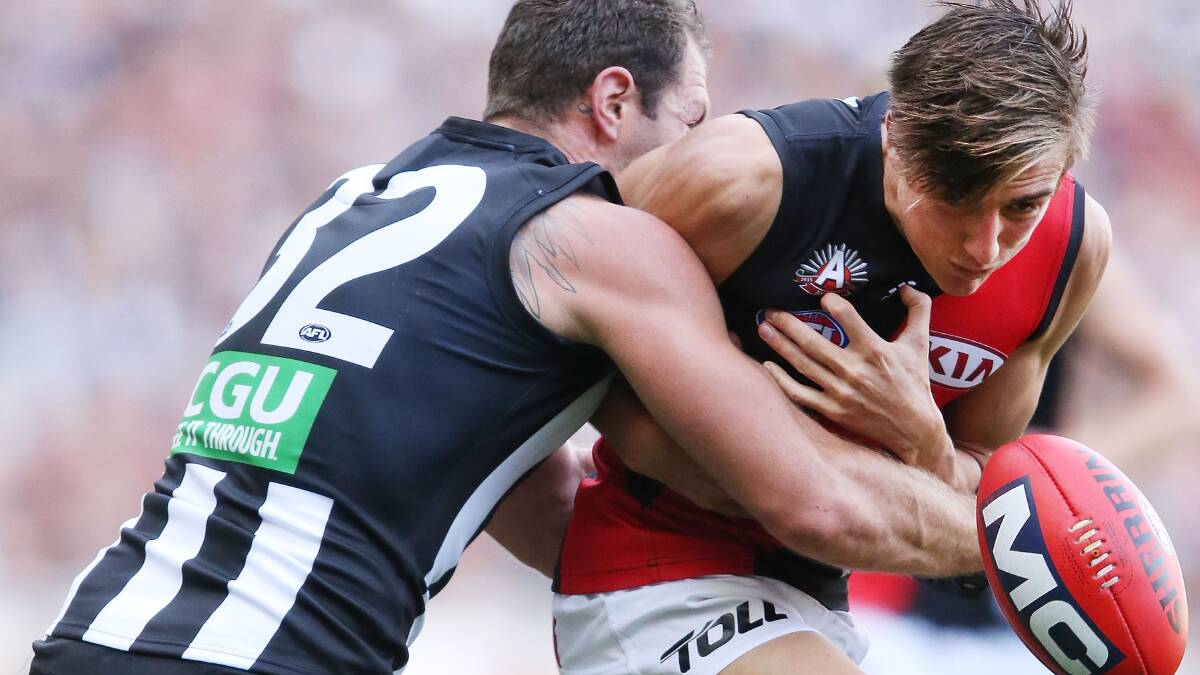 Travis Cloke of the Magpies tackles Jason Ashby of the Bombers. Photo: Getty Images.