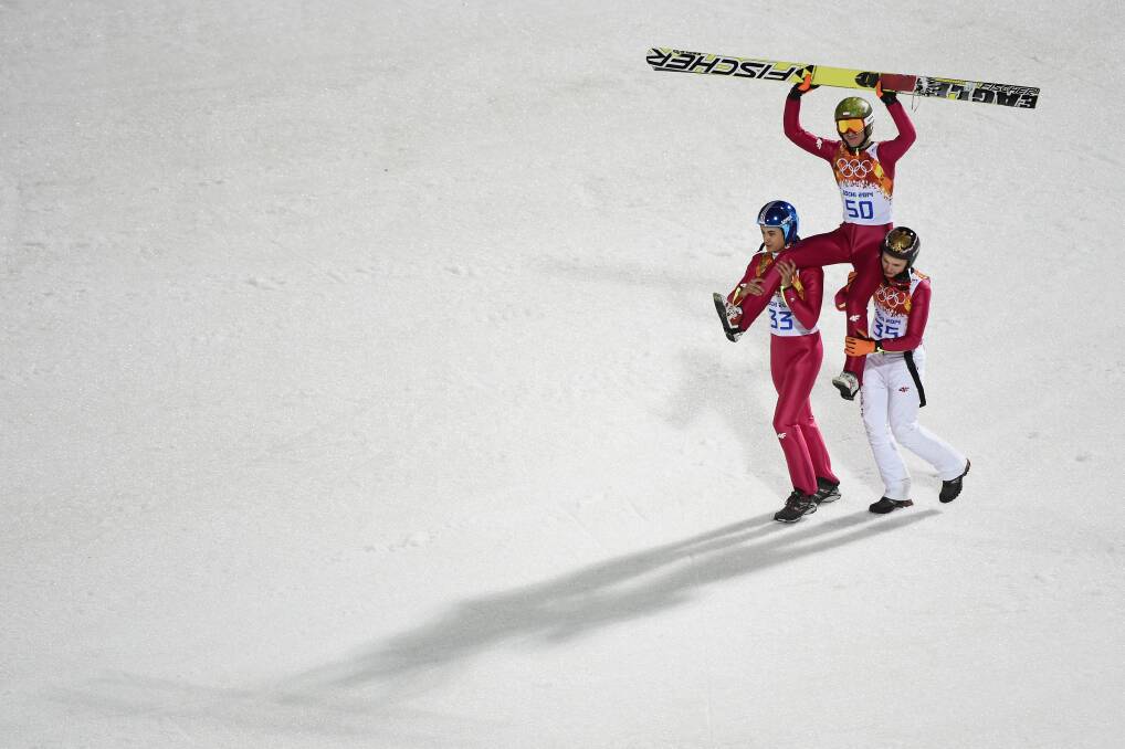 Gold medlaist Kamil Stoch of Poland is lifted on the shoulders of Maciej Kot of Poland and Jan Ziobro of Poland after the Men's Large Hill Individual Final Round on day 8 of the Sochi 2014 Winter Olympics at the RusSki Gorki Ski Jumping Center on February 15, 2014 in Sochi, Russia. Photo: GETTY IMAGES