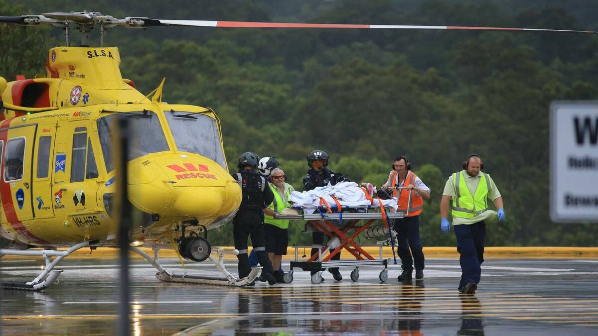 DASH: Paramedics rush the injured woman to hospital on Sunday.