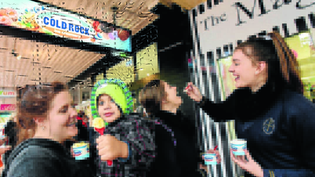 ROCKS IN THEIR HEAD: Jess Orcher, Hunter Orche, 3, Sophie Pennell, 15, and Izzy Ambrose, 16, brave the freezing conditions to sample the delights on offer at Cold Rock Ice Creamery, which opened in Peel St yesterday. Photo: Gareth Gardner