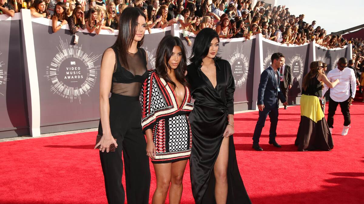 Kendall Jenner, Kim Kardashian and Kylie Jenner arrive at the 2014 MTV Video Music Awards. PHOTO: Getty Images