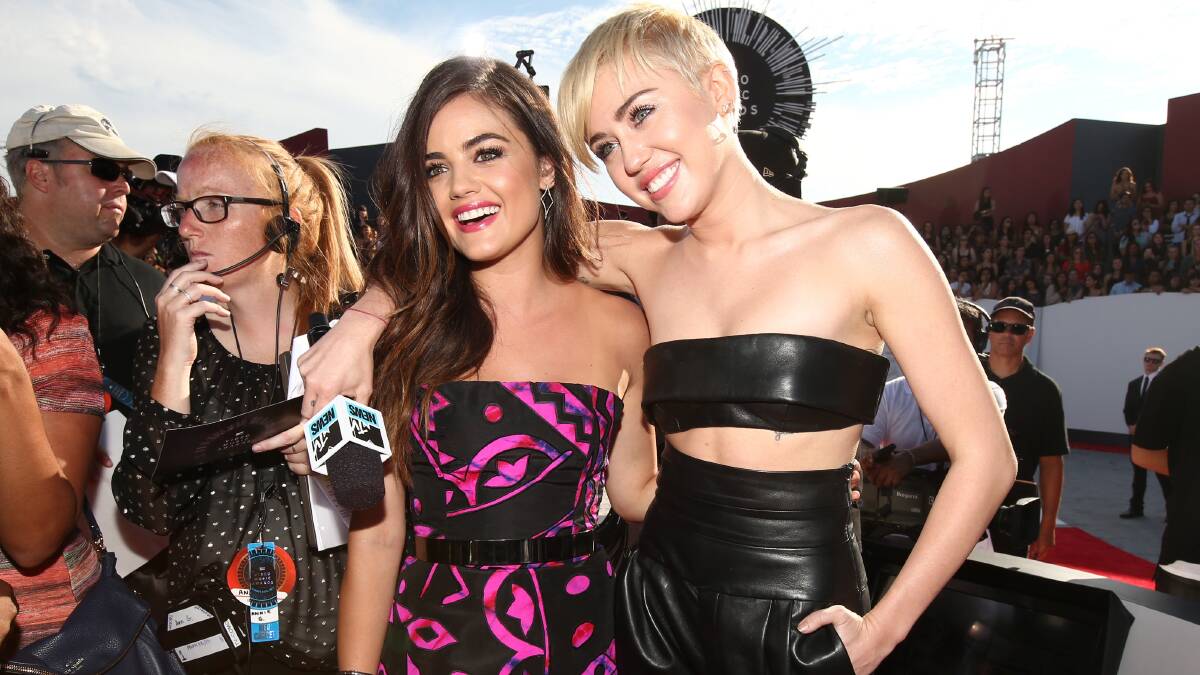 Actress Lucy Hale (L) and Miley Cyris attend the 2014 MTV Video Music Awards. PHOTO: Getty Images