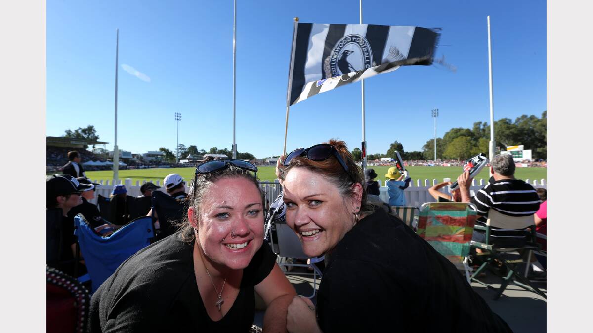 Kim Trickey and Karyn Wright, flying the flag for the Magpies behind the goals at the Norm Minns Oval, Wangaratta.