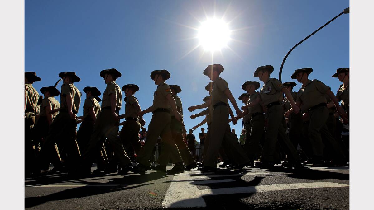 Wodonga Anzac Day parade. Soldiers march past the crowd in the morning sun.