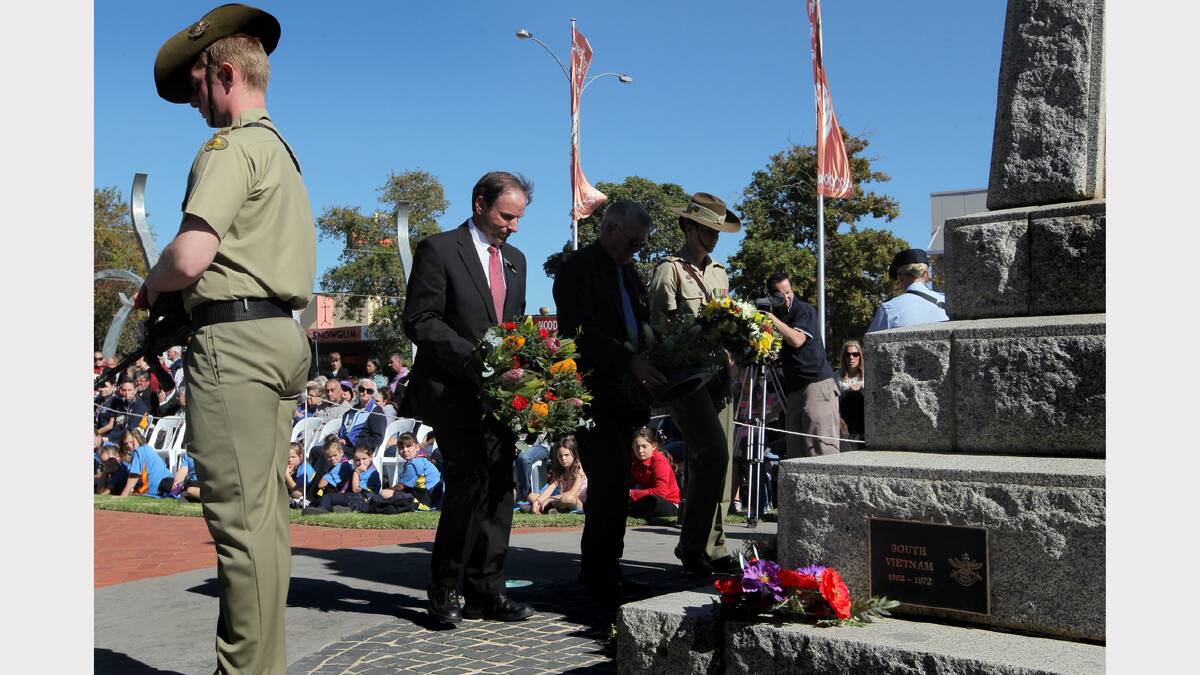 Wodonga mayor Rodney Wangman, RSL president Kevyn Williams and Major Angela Dent lay wreaths at the cenotaph.