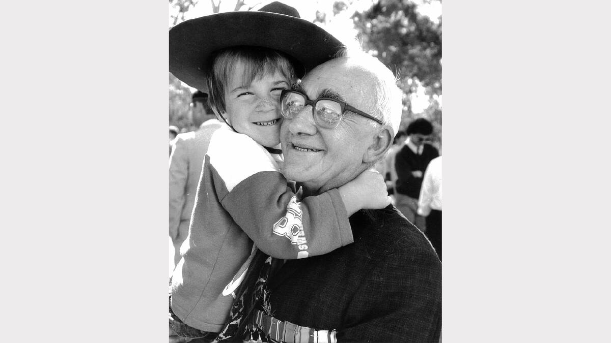 1989 Anzac Day parade: Trent Ball, 4, wears his father's slouch hat while hugging grandfather Allan Ball, a World War II veteran who was in the 7th Division. 