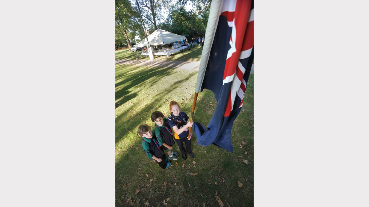 L-R: Riley Jones, 10, and Liam Jones, 12, of the 3rd/4th Scout Group, and Jessica Lewis, 13, of the Monak Guides, were part of the flag raising ceremony.