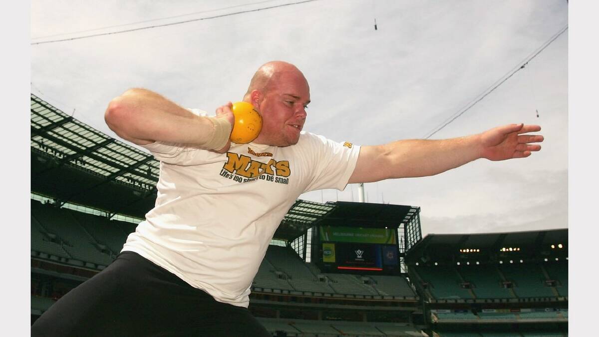 Scott Martin has a practice throw as he warms up for the final of the men's shot put during the Victorian Athletic Championships day three at the MCG.