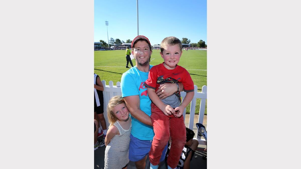 Luke Bailey (centre) and his children Bronte, 7, and Callum, 4, of Wangaratta, at the Norm Minns Oval, Wangaratta.