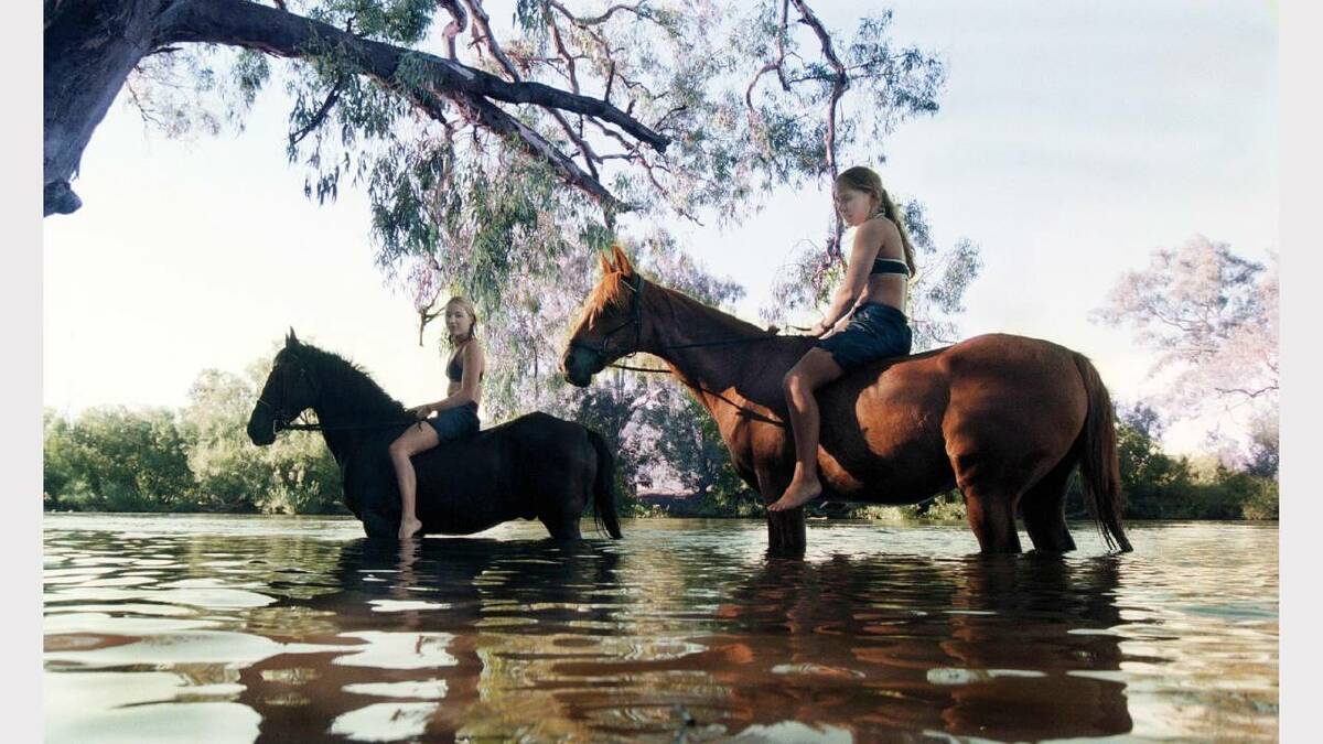 Jenny Karlsson, 16, with her horse, Rocky with Sarah Halpin, 16, of Albury, with her horse, Blackjack. The girls and their horses come down to Noreuil Park every day for a swim. Picture: ALEX MASSEY