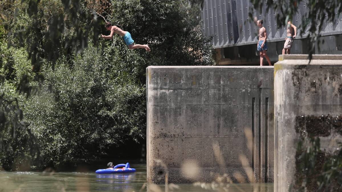 “It’s a bit of fun”: Teenagers jump from the Union Bridge after slipping through the $100,000 barriers put up last month to stop them. Pictures: JOHN RUSSELL
