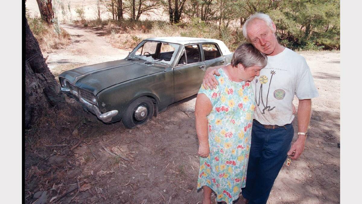 Deanna and Herbert Coyle with what is left of their car after it was stolen.