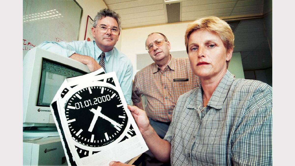 Dealing with the millennium bug. Pictured is Peter Lamb, acting head of the School of Business, La Trobe University Albury-Wodonga, Leo O'Reilly, lecturer in accounting, School of Business, and Angela Dwyer, lecturer in law, School of Business.