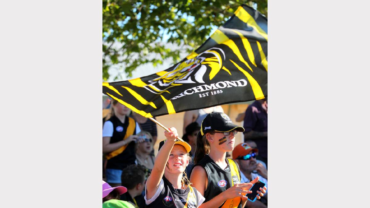 Annie Marquison, 11, of Rutherglen, flying the Tigers flag at the Norm Minns Oval, Wangaratta.