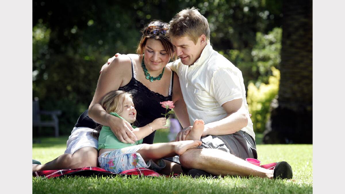 Haley Wright with daughter Ellie O'Neill, 3, and fiancee Aaron O'Neill, from Wodonga, enjoy a Valentines Day picnic together in the gardens. Picture: KYLIE GOLDSMITH