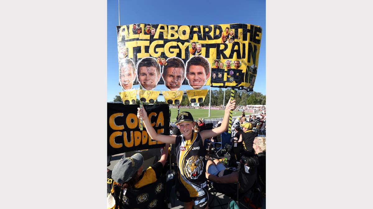 Jesse Kelly, 12, of Drouin, made up a sign to support the Tigers at the Norm Minns Oval, Wangaratta