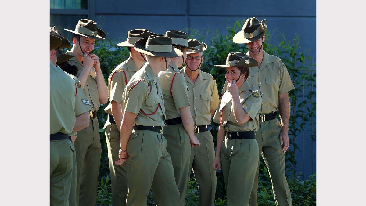 Wodonga Anzac Day march. Private Caitlin Richmond shares a joke with her RAAOC colleagues prior to the march.