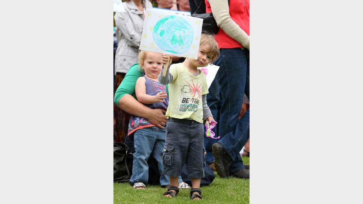 Ruth Merton, 2, being held by her mother Veronica Merton (obscured), and Arthur Merton, 4, of Wodonga, at the March in March protest objecting to the Abbott Government, held in Woodland Grove, Wodonga.